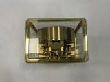 a gold clock on a white surface with a white background