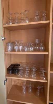 many glasses on the shelves in the kitchen