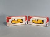 two yellow school buses are sitting on a table next to each other