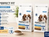 two bags of perfect fit puppy food sitting next to a bowl of dog food