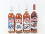three bottles of wine sitting next to each other on a white surface