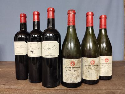 several bottles of wine are lined up on a wooden table