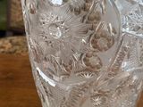 a glass vase sitting on a wooden table