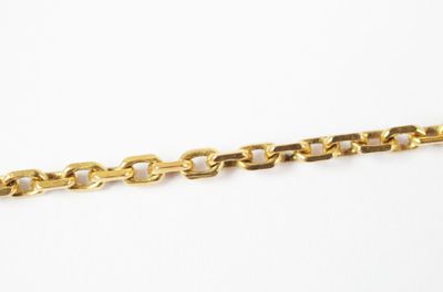 a close up of a gold chain on a white background