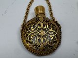 a gold pocket watch with a chain hanging from it