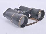 an old pair of binoculars sitting on top of a white surface