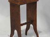 an old wooden table with a book on top of it