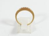 a close up of a gold ring on a white surface