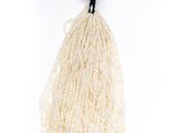 a white string bag filled with white beads on a white background
