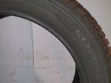 a close up of a tire on a white surface