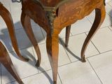 a small wooden table with a clock on top of it