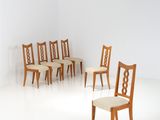 several chairs in a room with a white floor and a white wall