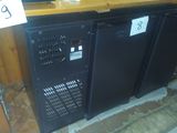 two black refrigerators sitting next to each other on a counter