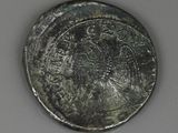 a close up of a silver coin with a bird on it