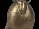 an image of a gold statue of a bull on a black background