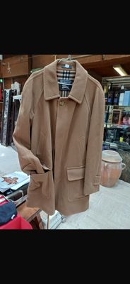a coat hanging on a rack in a clothing store