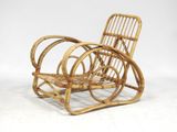 a wicker chair that is sitting on a white surface