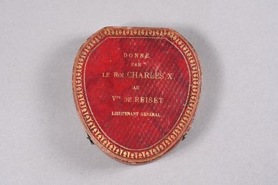 a red box with writing on it sitting on a table
