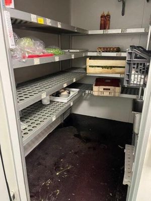 a pantry with shelves and bins of food inside of it