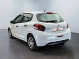 the back of a white car in a room with a black floor