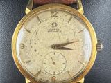 a close up of a wrist watch with a brown leather strap
