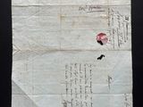 a piece of paper with writing on it on a black surface