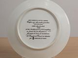 a plate with a poem on it sitting on a table