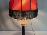 an image of a lamp with a red shade on top of it