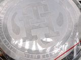 a close up of a watch on a white surface