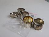 five silver cups sitting on a table with a price tag