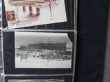 a bunch of old photos on a binder on the floor