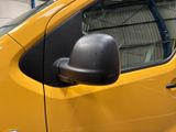 a small yellow car parked in a parking lot