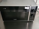 a microwave sitting on top of a stainless steel counter