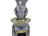 a blue and gold tea pot and saucer on a white background