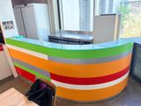 a kitchen with a colorful counter top and a refrigerator