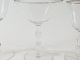 three wine glasses sitting next to each other on a table