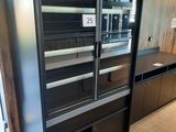 an image of a kitchen with a refrigerator and cabinets