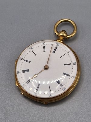 une montre de poche en or avec des chiffres romains