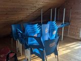 many blue chairs in a room with wooden walls