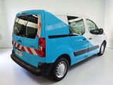 a blue van that is parked in a white room