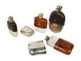 five different types of perfume bottles on a white surface