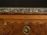 a wooden cabinet with a marble top and a brass handle