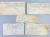 four pieces of paper with writing on them on a blue surface