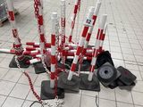 a bunch of red and white poles on the ground