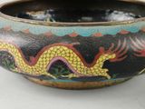 a bowl with a dragon painted on it on a table