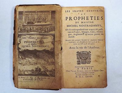 an old book that is open on a white surface