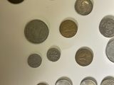 a lot of coins that are on a white surface