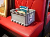 a red chair with a box on it next to a picture