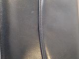 black leather case for a cell phone sitting on a table