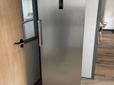 a stainless steel refrigerator in the corner of a room